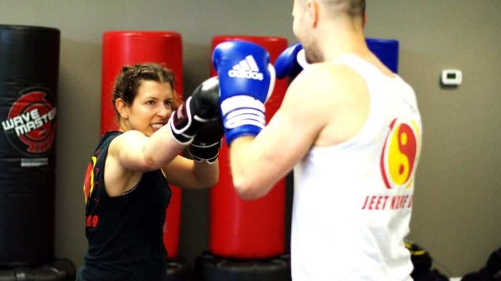 A student practicing a partner drill with Coach Forrest